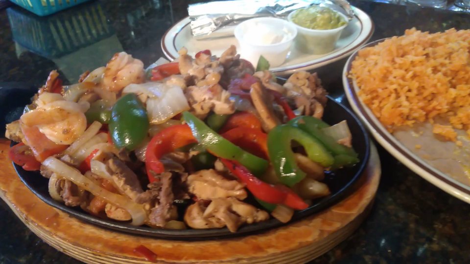 A takeout meal arranged beside wrapped utensils.